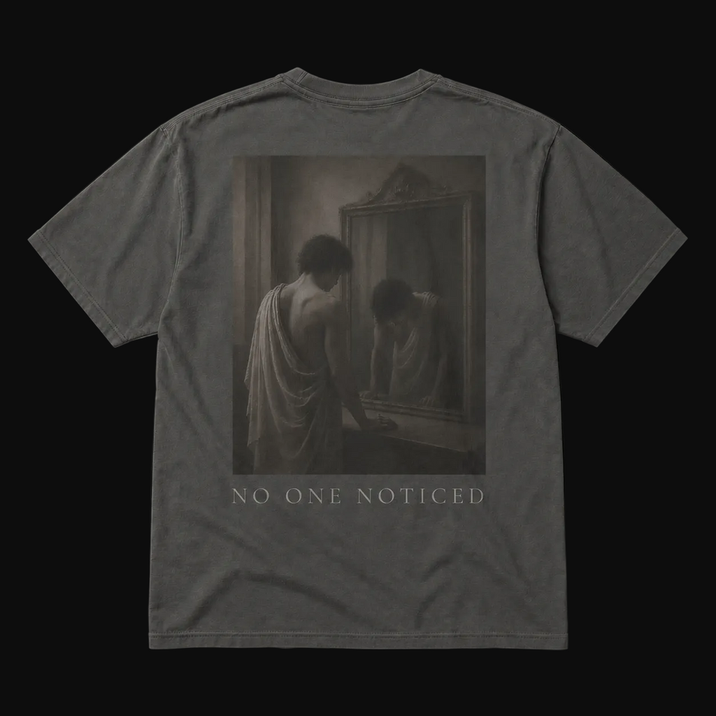 T-shirt with a graphic of a person looking at themselves in a mirror with 'No One Noticed' text on a black background